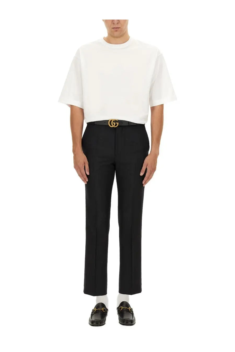 Black gucci belt with gold toned interlocking g buckle paired with gucci men’s wool blend twill pants black