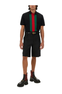 Black gucci polo shirt with bold red and green vertical stripes paired with men’s wool blend twill shorts black