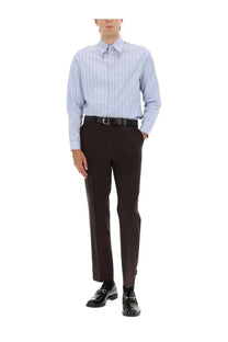 Light blue and white vertically striped long-sleeved button-down shirt paired with gucci men’s black wool gabardine pants