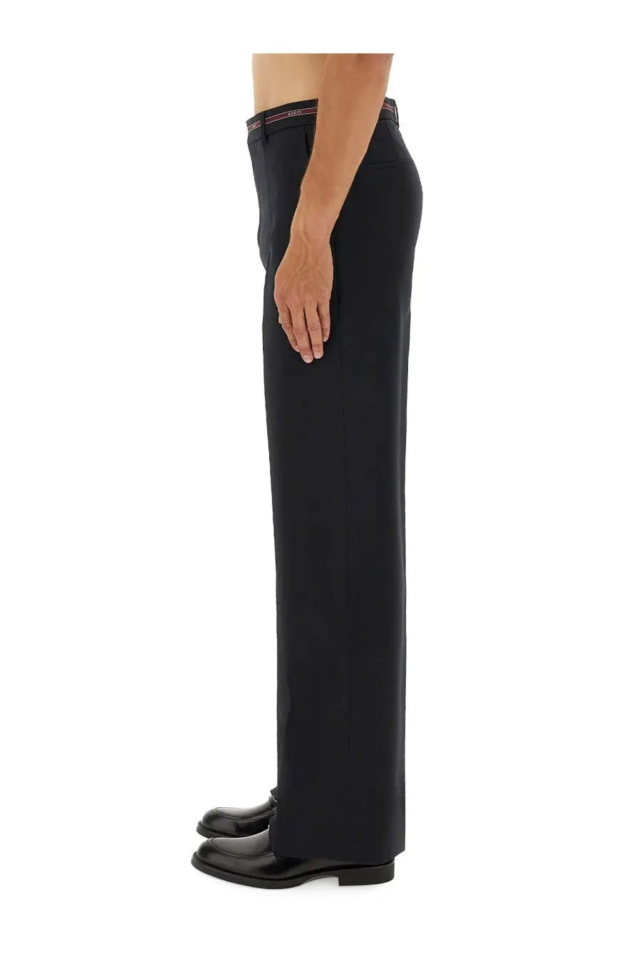 Black tailored wool trousers with slim fit and subtle striped waistband detail from Gucci men’s collection