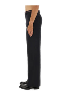 Black tailored wool trousers with slim fit and subtle striped waistband detail from Gucci men’s collection