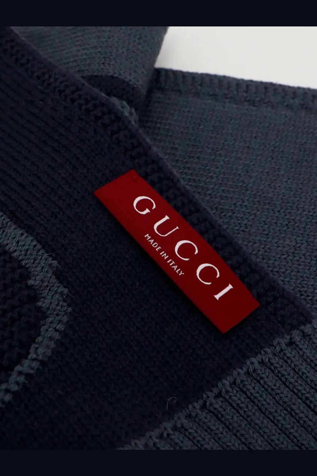 Gucci men’s dark navy wool knit sweater with red Gucci made in Italy label for stylish winter wear