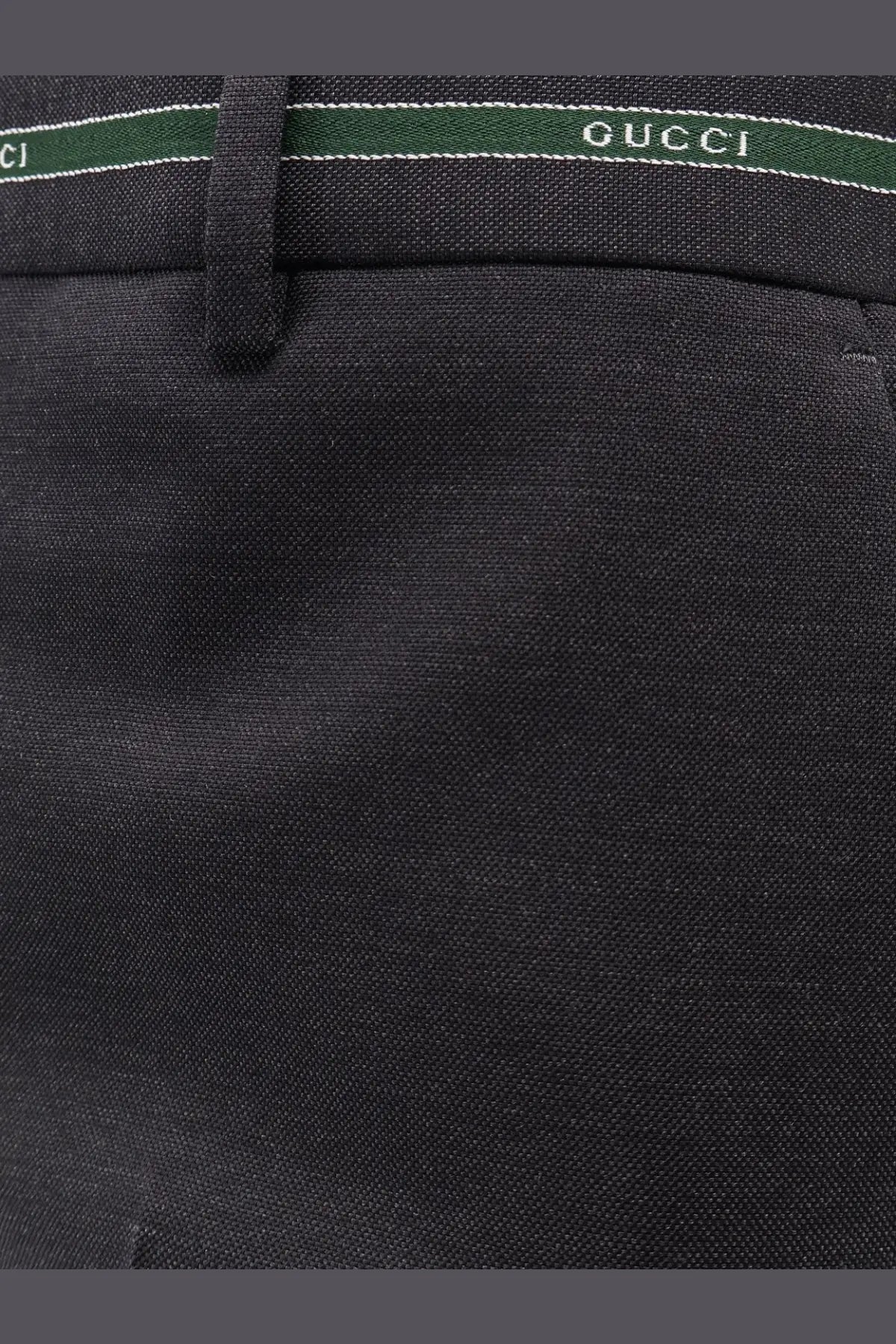 Black Gucci men’s wool trousers with textured weave and contrasting green waistband with white lettering detailing