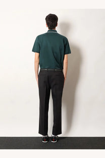 Dark green short-sleeved polo shirt with white collar trim paired with gucci men’s grey wool trousers