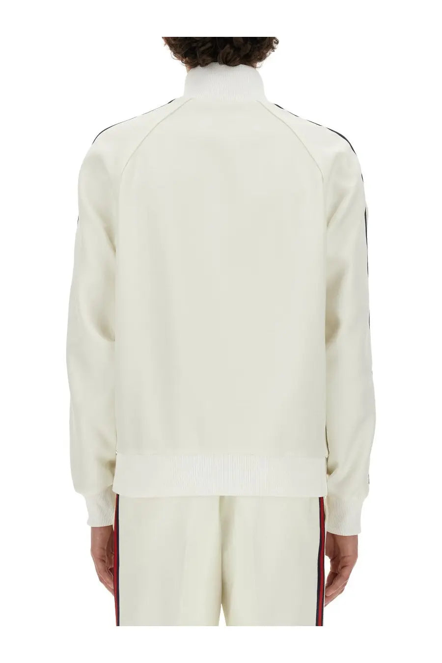 Gucci men’s cream-colored zippered track jacket with black and red striped accents on sleeves and pants