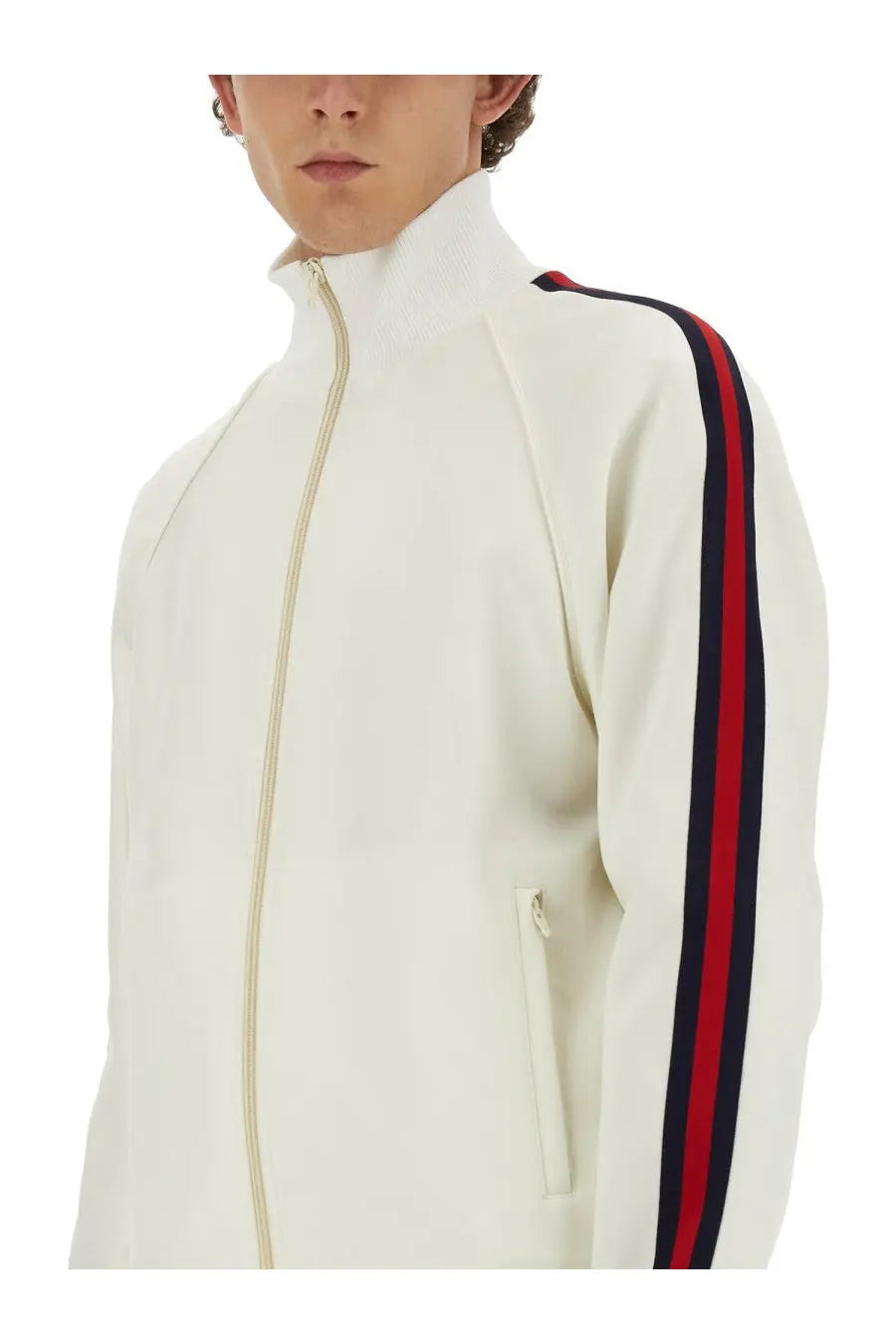 Gucci men’s cream-colored zippered track jacket with bold red and navy sleeve stripes and a high collar