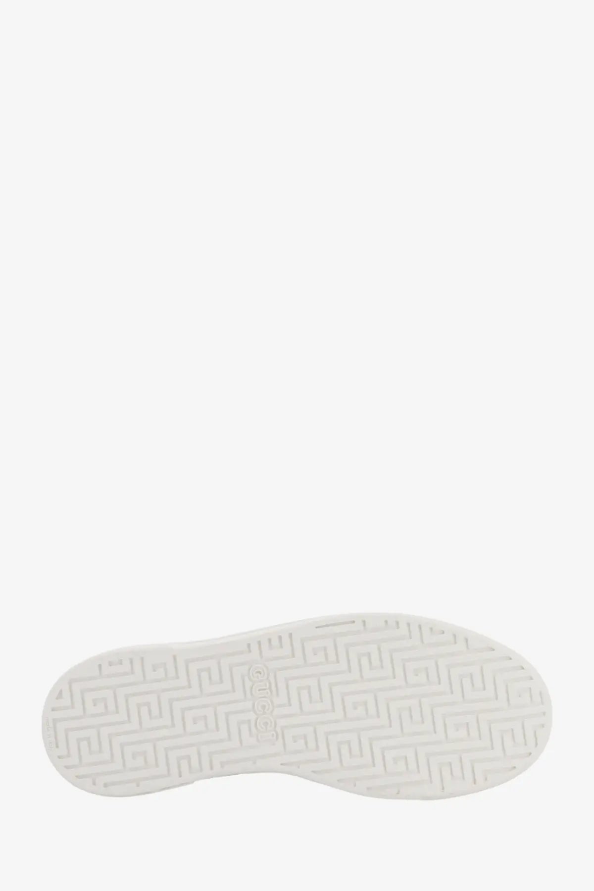 White rubber sole with geometric pattern and gucci embossed on the back of green ace leather sneakers for women
