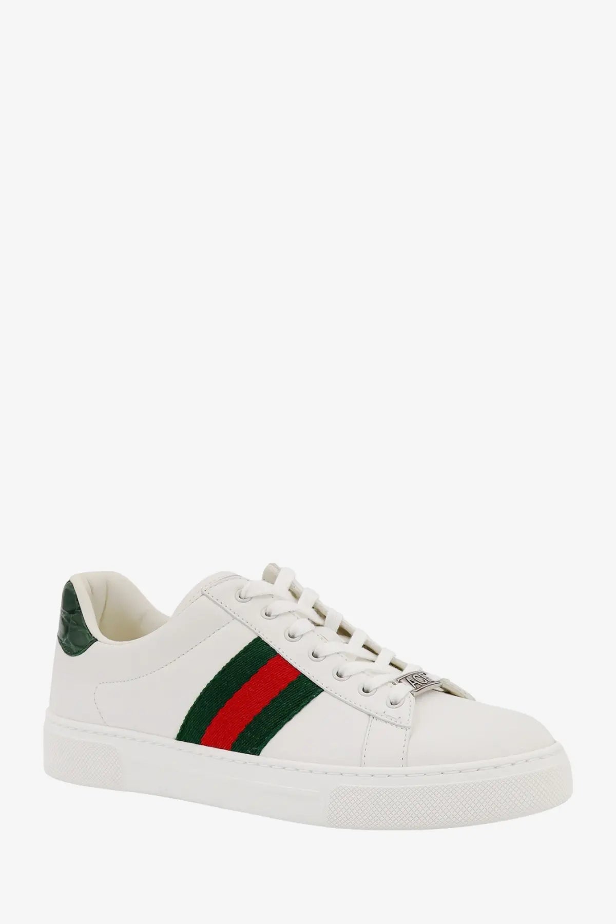 White Gucci women’s Ace leather sneaker with bold red and green striped band and metallic hardware on the side