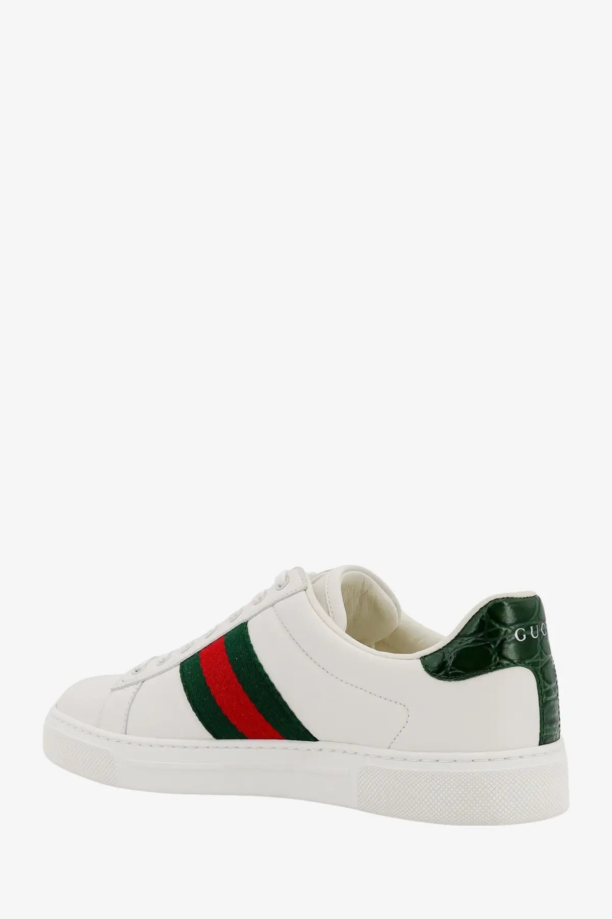 White Gucci women’s ace leather sneaker with green and red striped band and crocodile-textured heel tab
