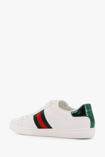 White Gucci women’s Ace leather sneakers with red and green stripes and emerald-green snake-skin heel tab back view