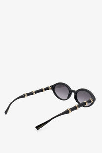 Gucci women’s black acetate sunglasses with bamboo-inspired gold-tone accents and gradient gray lenses