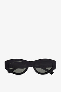 Gucci women’s black acetate cat-eye sunglasses with dark gray lenses and a sleek glossy frame