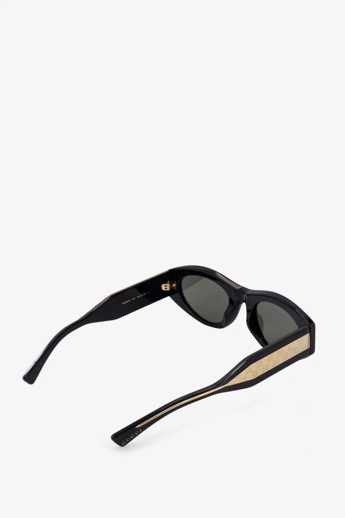 Gucci women’s black acetate sunglasses with dark gray lenses and gold-toned interlocking G pattern on temple tips
