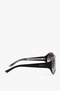 Gucci women’s acetate sunglasses in black with sleek glossy frames and gradient gray lenses