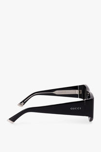 Gucci women’s acetate sunglasses in black with sleek rectangular frames and metallic temple accents