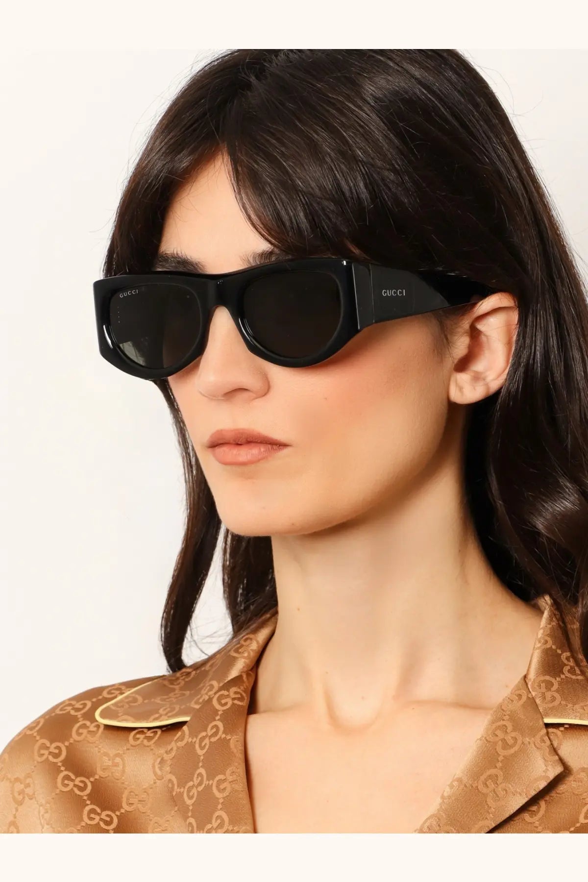 Black Gucci women’s acetate sunglasses with sleek rectangular frame and dark lenses for stylish sun protection