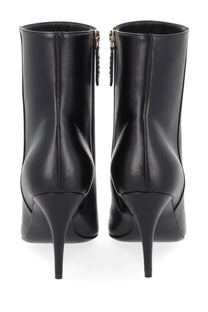 Gucci women’s black leather ankle boots with sleek glossy finish and gold-tone zippers on the back side