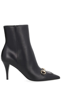 Gucci women’s black leather ankle boot with gold-tone horsebit buckle at the toe
