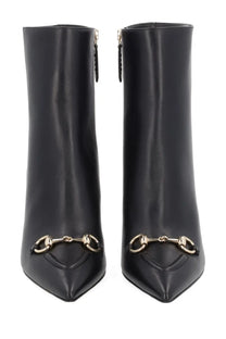 Black leather Gucci women’s ankle boots with gold-tone horsebit metal accents perfect for stylish wear