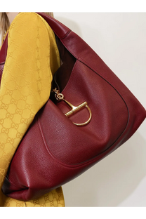 A rich burgundy leather Gucci women’s Borsa Spalla Softbit shoulder bag with gold-tone metal horsebit clasp