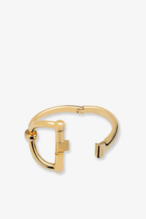 Gucci women’s gold-tone metal bangle bracelet with a distinctive horsebit-inspired clasp design