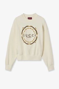 Cream-colored Gucci women’s brushed cotton jersey sweatshirt with bold gold and black circular chain logo on front