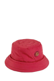 A vibrant red quilted Gucci women’s bucket hat with a gold-toned logo emblem on the side