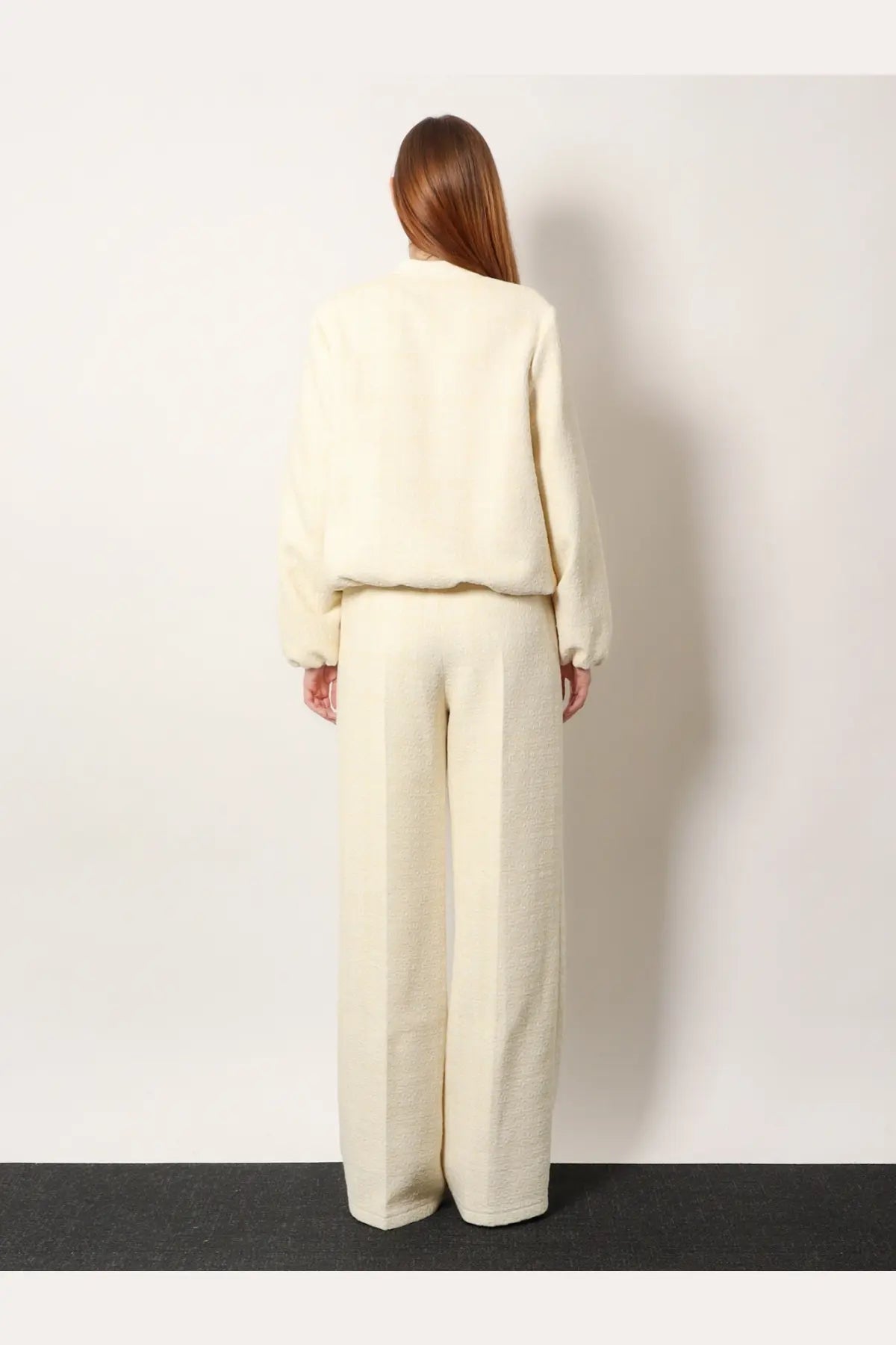 Cream-colored plush cropped sweater paired with gucci white cotton blend wide-leg trousers for women