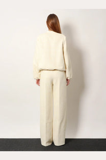 Cream-colored plush cropped sweater paired with gucci white cotton blend wide-leg trousers for women