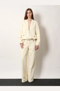 Cream-colored wool blend bomber jacket with front zipper and button accents paired with Gucci white cotton blend trousers