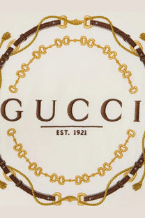 Gucci women’s white cotton jersey shirt with embroidered Gucci logo and brown gold chain belt motifs on fabric