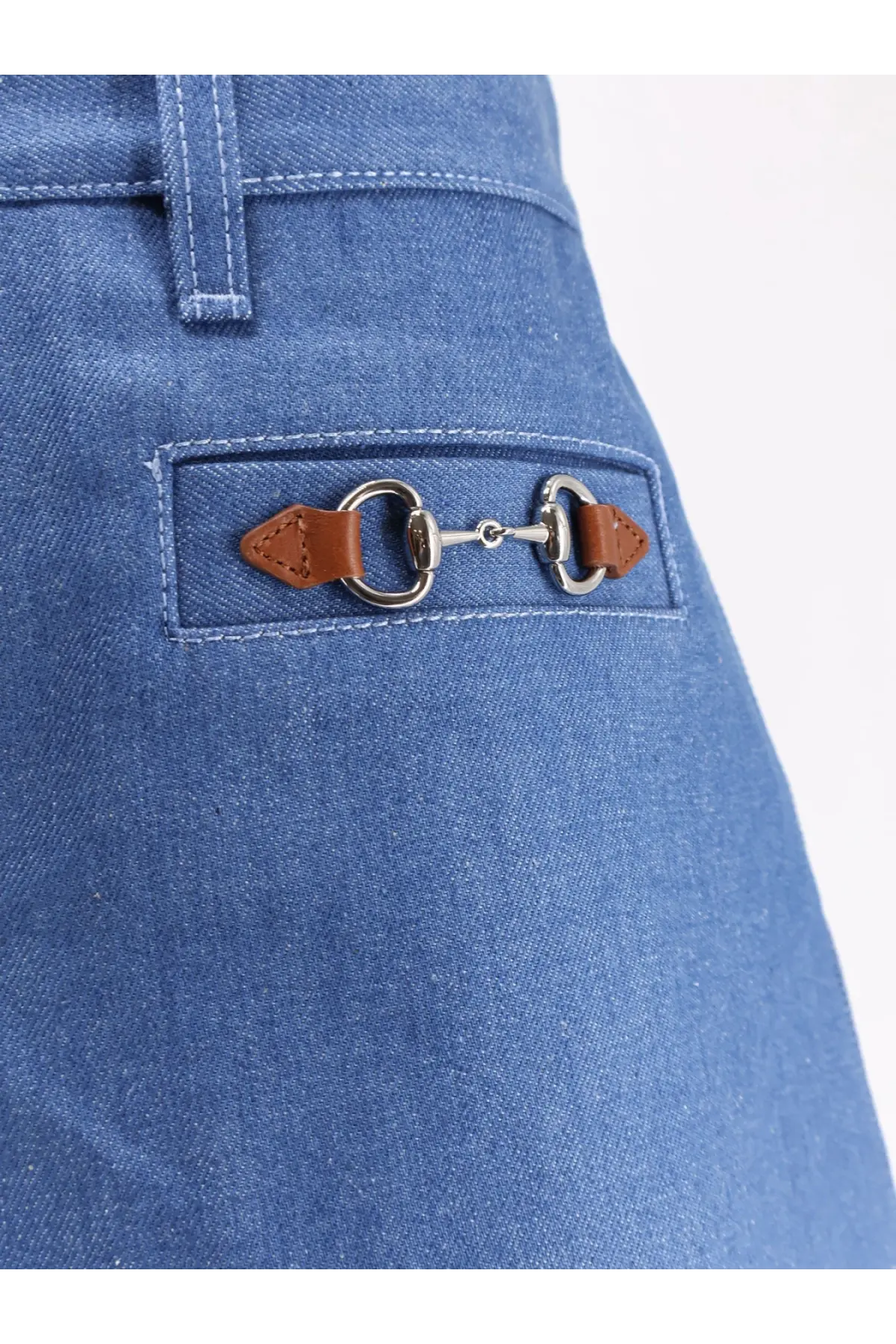 Back view of gucci women’s blue cotton shorts featuring blue denim fabric and brown leather horsebit buckle on pocket