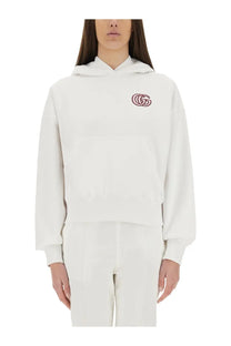 Gucci women’s white cotton sweatshirt with subtle pink embroidered logo on the chest