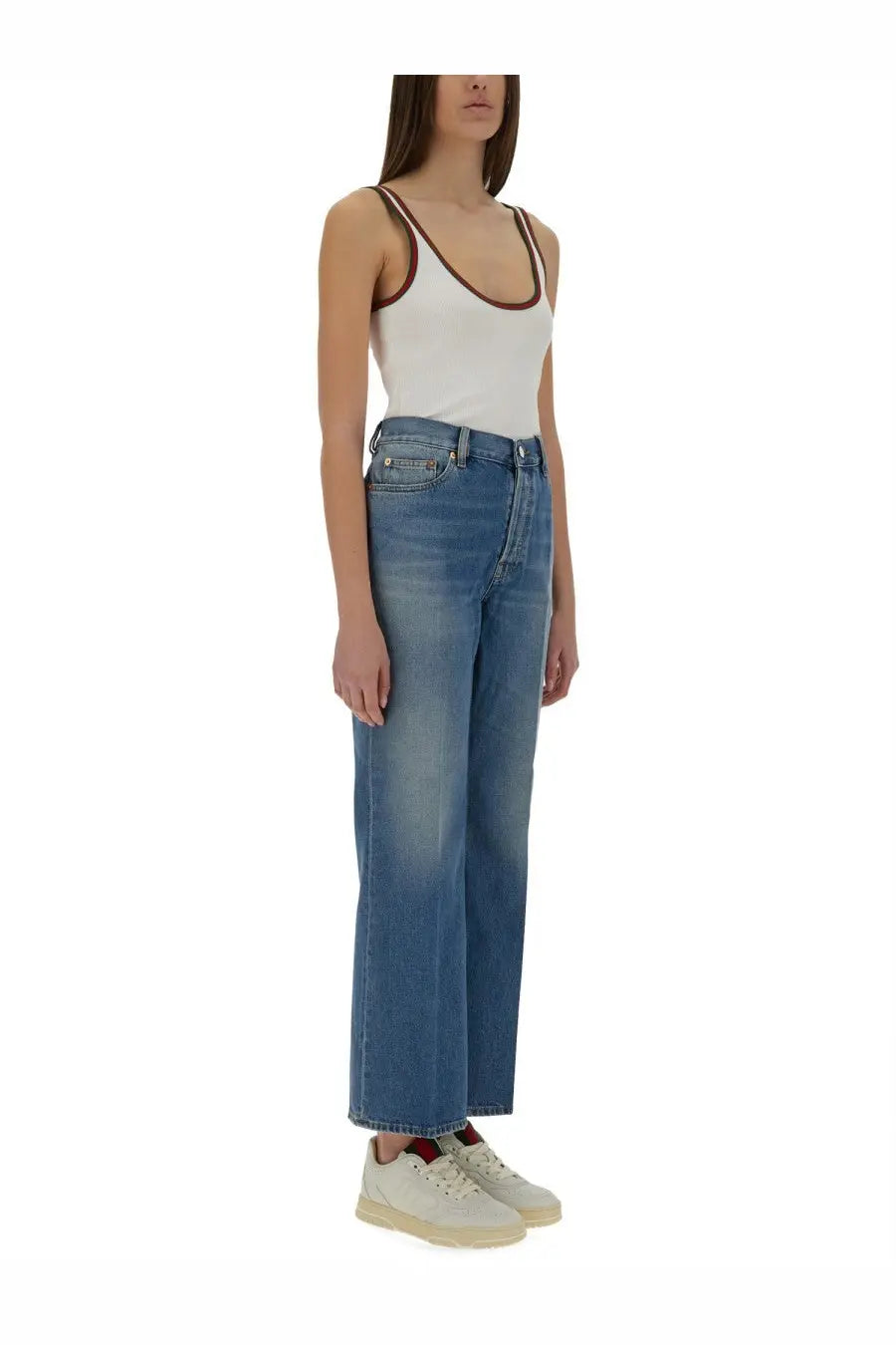 Gucci women’s high-waisted blue denim pants with a straight-leg cut paired with white tank top with brown trim straps
