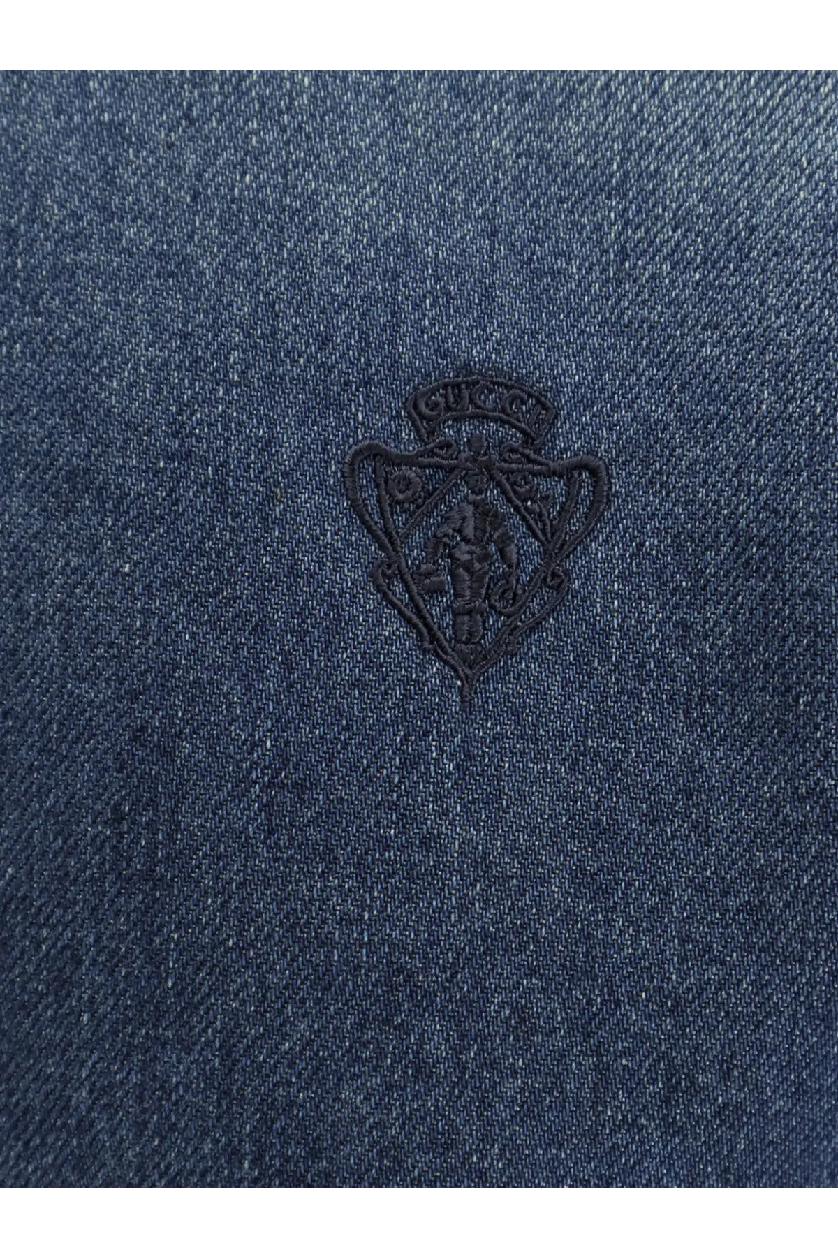 Dark blue denim shirt for women featuring a black embroidered gucci shield logo on the front