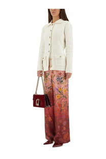 A glossy burgundy gucci marmont mini handbag with gold-tone clasp and chain strap paired with a white fine cotton cardigan