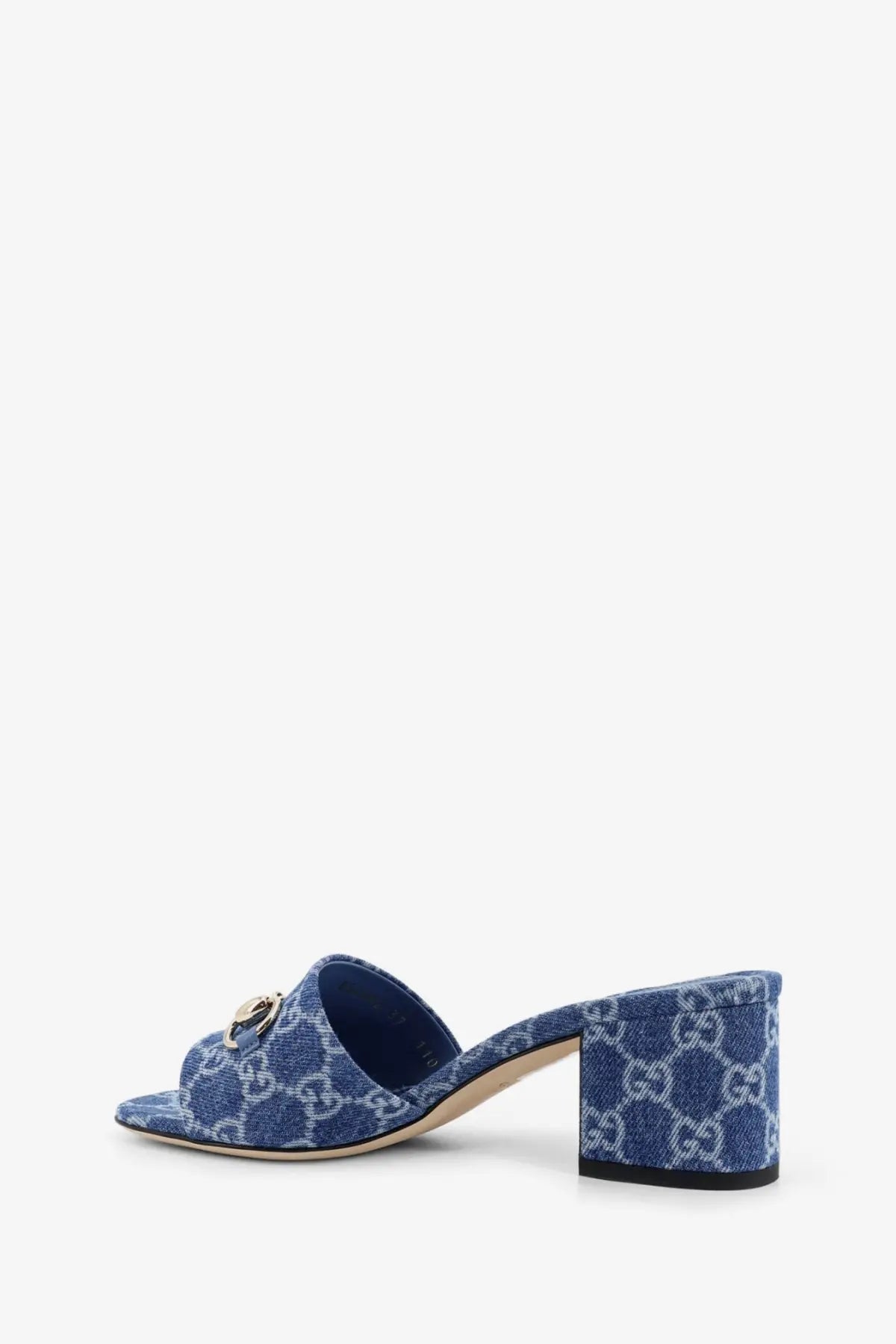 Gucci women’s blue denim sandals with white interlocking GG logo pattern and gold-tone metal horsebit detail