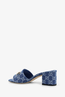 Gucci women’s blue denim sandals with white interlocking GG logo pattern and gold-tone metal horsebit detail
