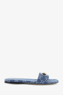 Gucci women’s blue denim slide sandal with metallic gold-tone buckle and denim pattern design
