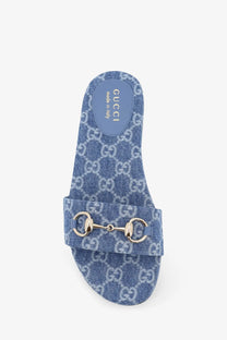 Blue denim Gucci women’s slide sandal featuring a metallic horsebit buckle for casual stylish wear