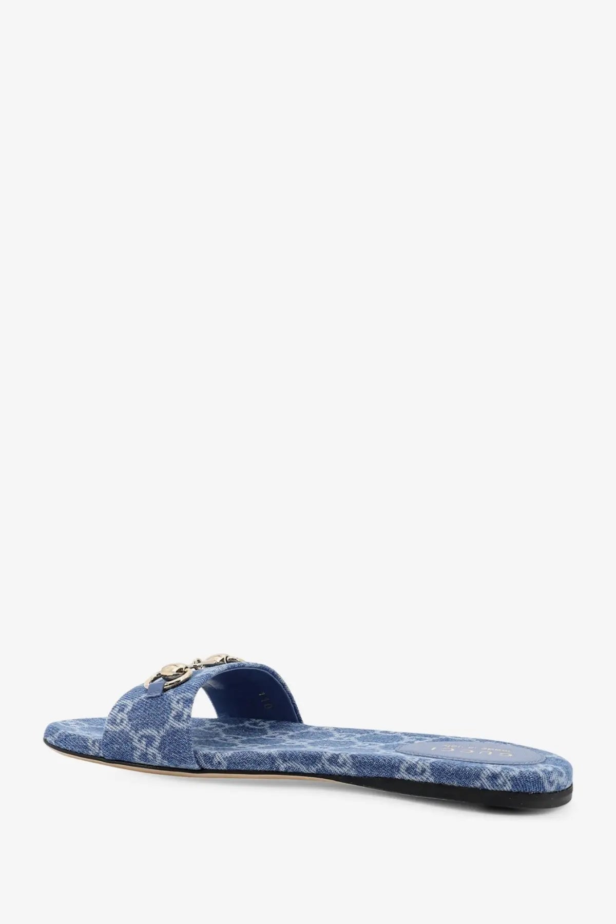 Gucci women’s blue denim slip-on sandal with gold-tone metal buckle detail