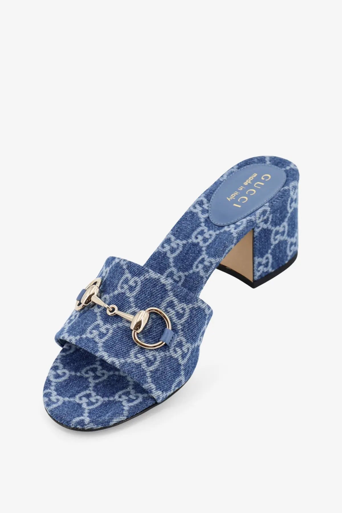 Blue denim textured Gucci women’s mule sandal with gold tone horsebit buckle and GG logo detailing