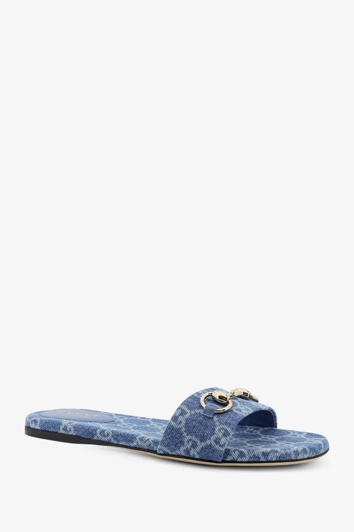 Blue denim-textured Gucci women’s slide sandal with gold-tone horsebit buckle and GG logo detailing