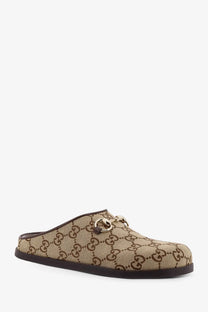 Beige and brown Gucci women’s GG fabric sabot slip-on mule with gold-tone horsebit detail in canvas material