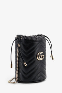 Black quilted leather Gucci women’s GG Marmont bucket bag with gold-tone GG logo and chain strap