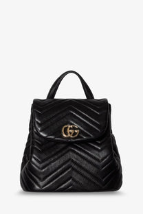 Black quilted leather Gucci women’s GG Marmont mini backpack with gold-tone interlocking GG logo clasp