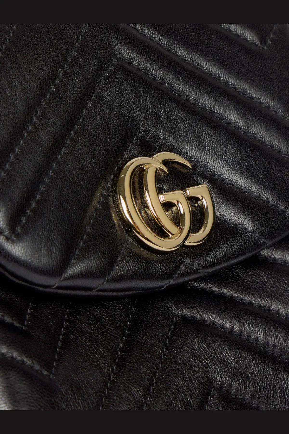 Gucci women’s GG marmont mini leather backpack in black quilted leather with gold-tone interlocking GG logo clasp