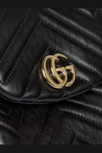 Gucci women’s GG marmont mini leather backpack in black quilted leather with gold-tone interlocking GG logo clasp