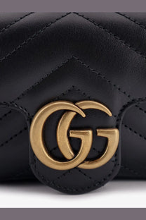 Black quilted leather gucci marmont mini crossbody bag with gold-tone interlocking gg logo for women