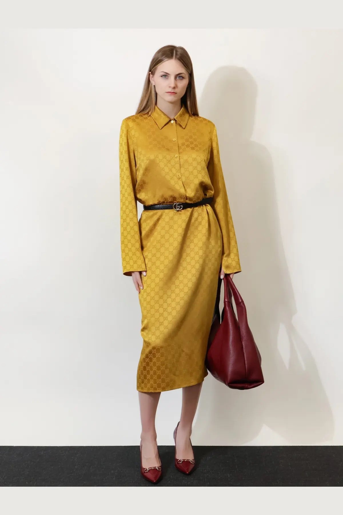 Golden Gucci women’s satin chemisier dress with long sleeves and repeating monogram pattern